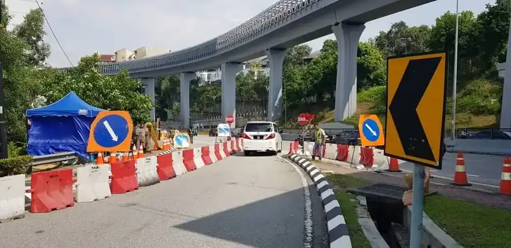 active road construction works Malaysia barriers cones directional signs